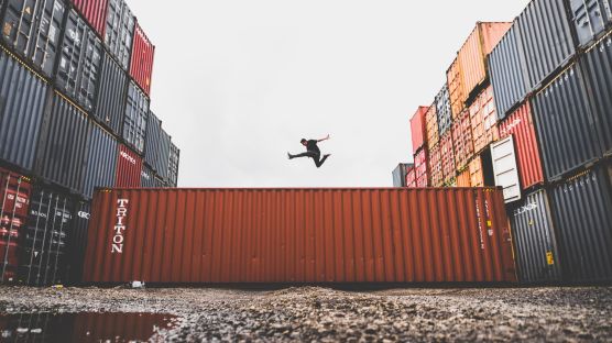 Man jumping on a shipping container